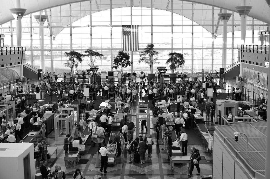 a black and white photo of people in an airport